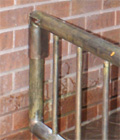 close-up of residential security gate latch on front porch this custom gate built from brass tube
