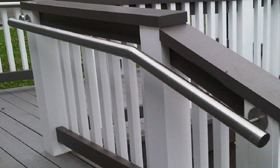commercial stainless steel hand rail on wooden fence and deck ramp Toronto area image
